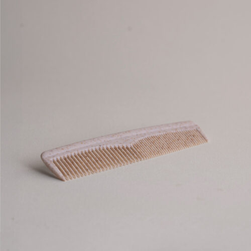 Small plastic hair comb with crushed straw